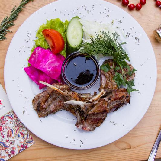 Char grilled lamb ribs marinated in white wine with herbs e1635007315408
