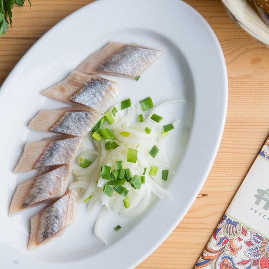 Herring with onion garnish e1634990500775