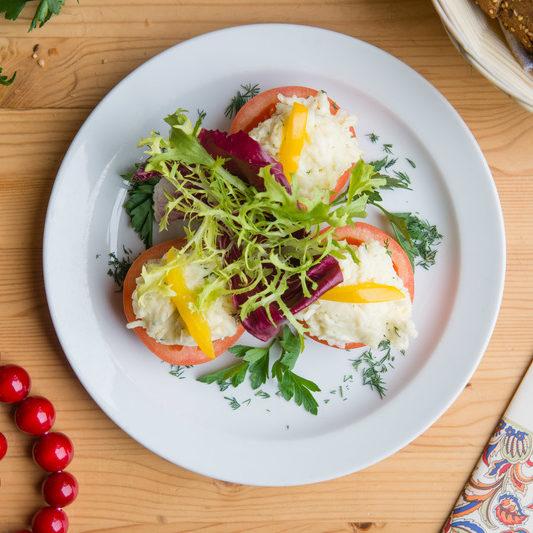 Tomatoes stuffed with cheese greens garlic and mayonnaise e1634902314970